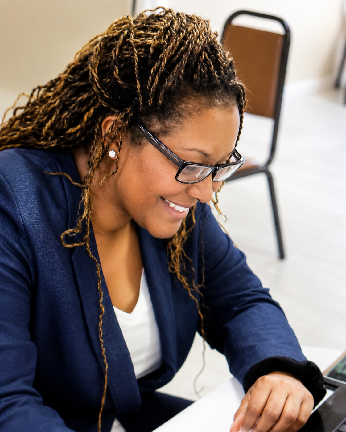 Dr. Ursula T. Wright smiling as she works at her laptop
